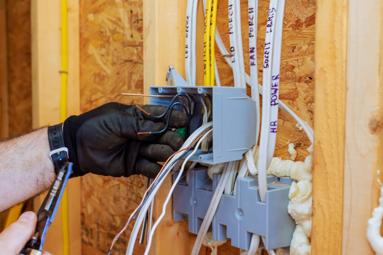 Electrician working on circuit box AEO Marketing Services 2